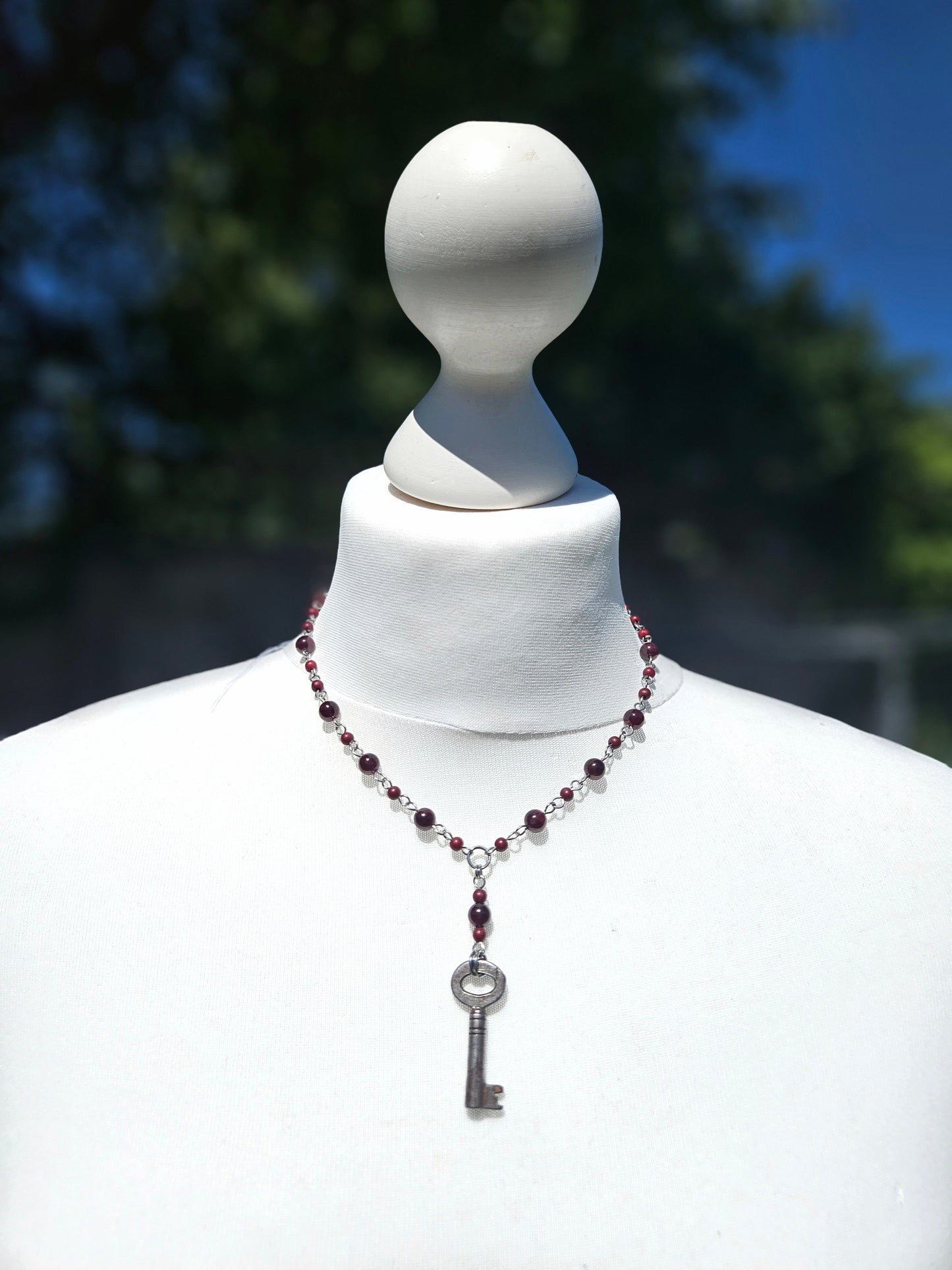 Garnet necklace with an antique key