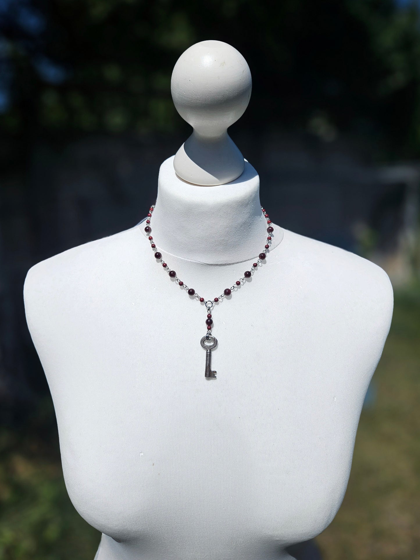 Garnet necklace with an antique key
