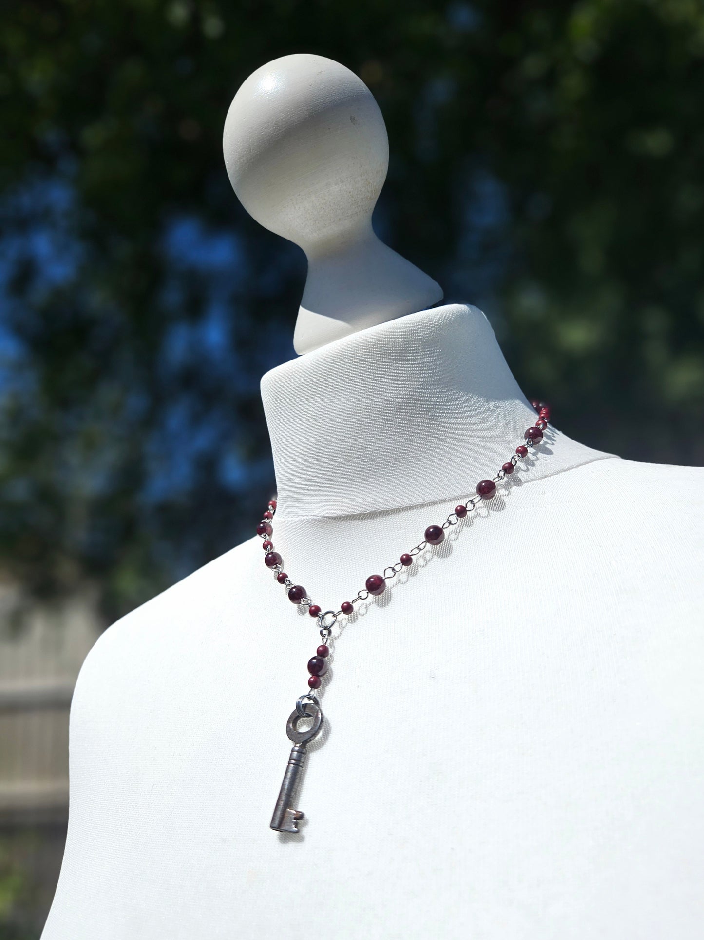 Garnet necklace with an antique key