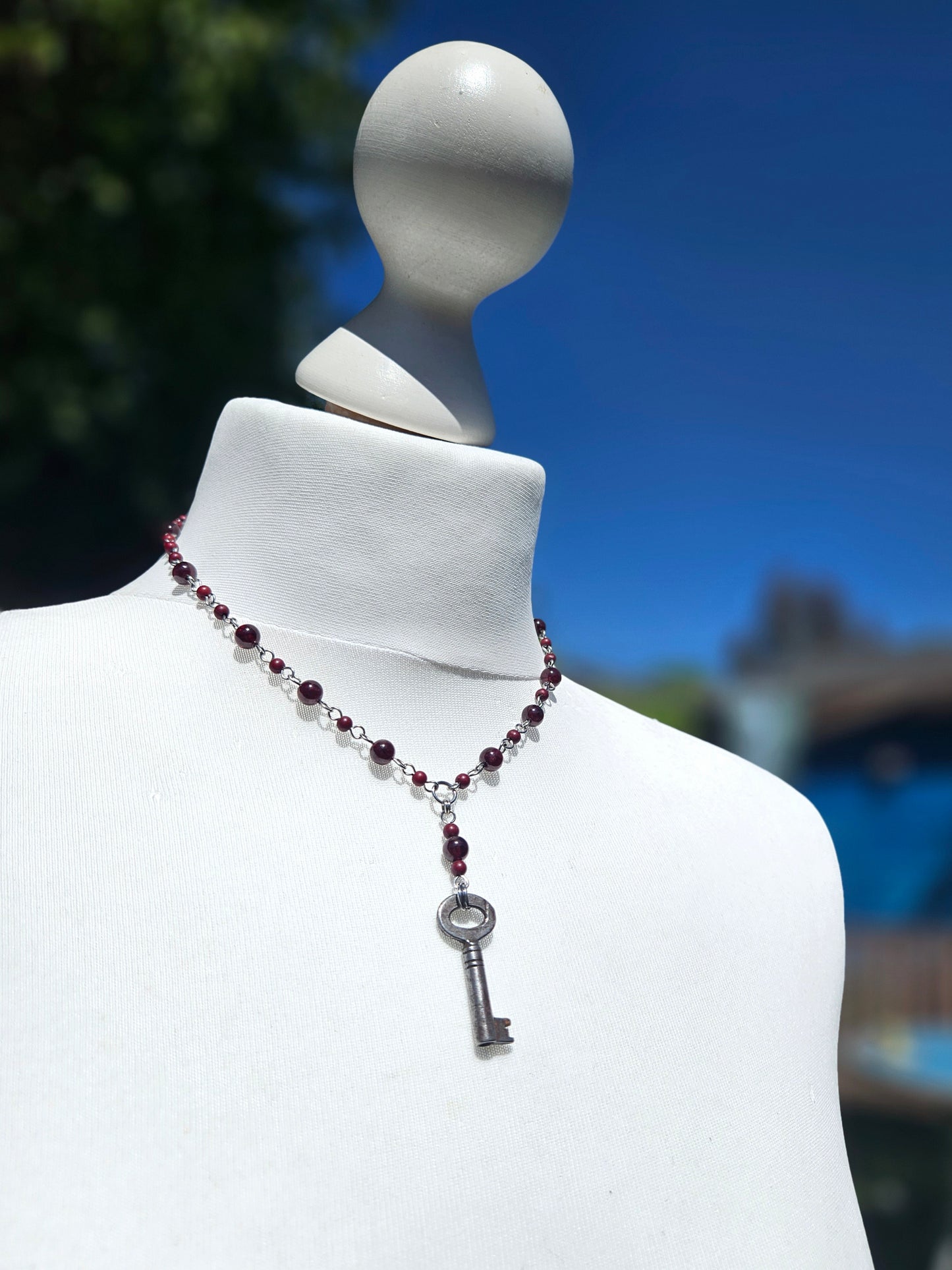 Garnet necklace with an antique key